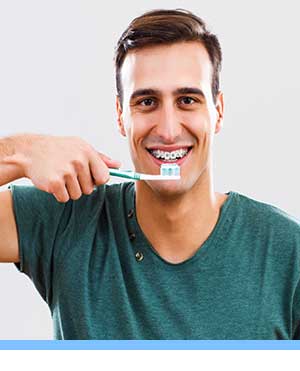 Caring for Braces interior photo man brushing Elite Orthodontics San Diego CA